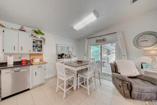 a view of a dining room with furniture and a chandelier