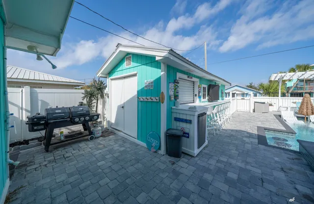 a view of a house with backyard and sitting area