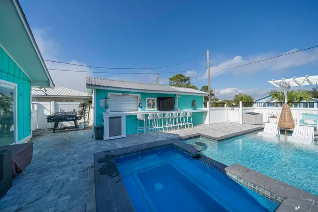 a view of a house with backyard porch and sitting area