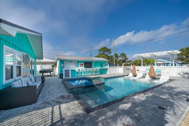 a view of a house with backyard porch and sitting area