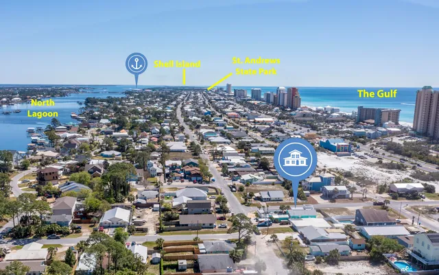 an aerial view of a swimming pool with outdoor seating