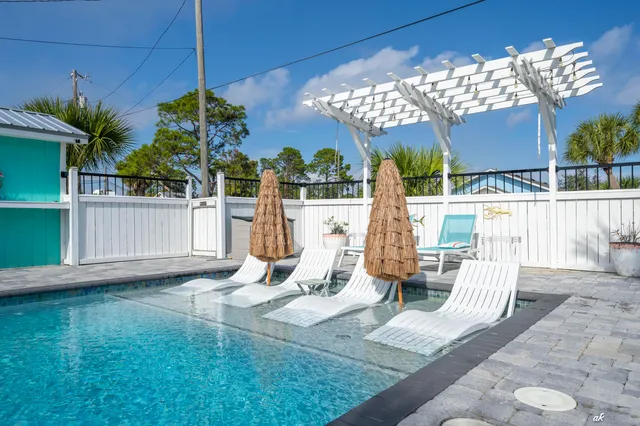 a view of a house with backyard and sitting area