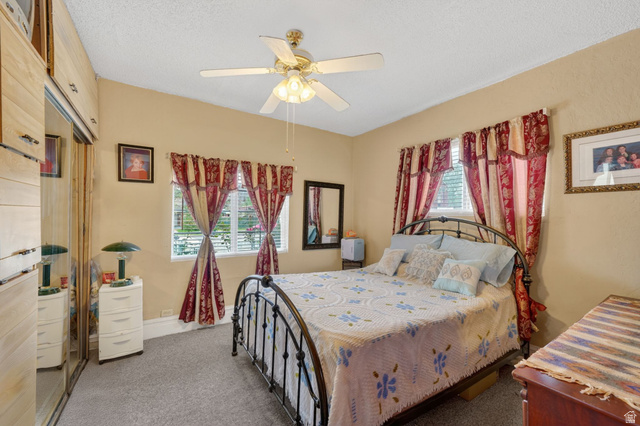 977 23rd Street Ogden, UT 84401 - Photo 6 of 29 Bedroom with dark colored carpet, a ceiling fan, and a textured ceiling