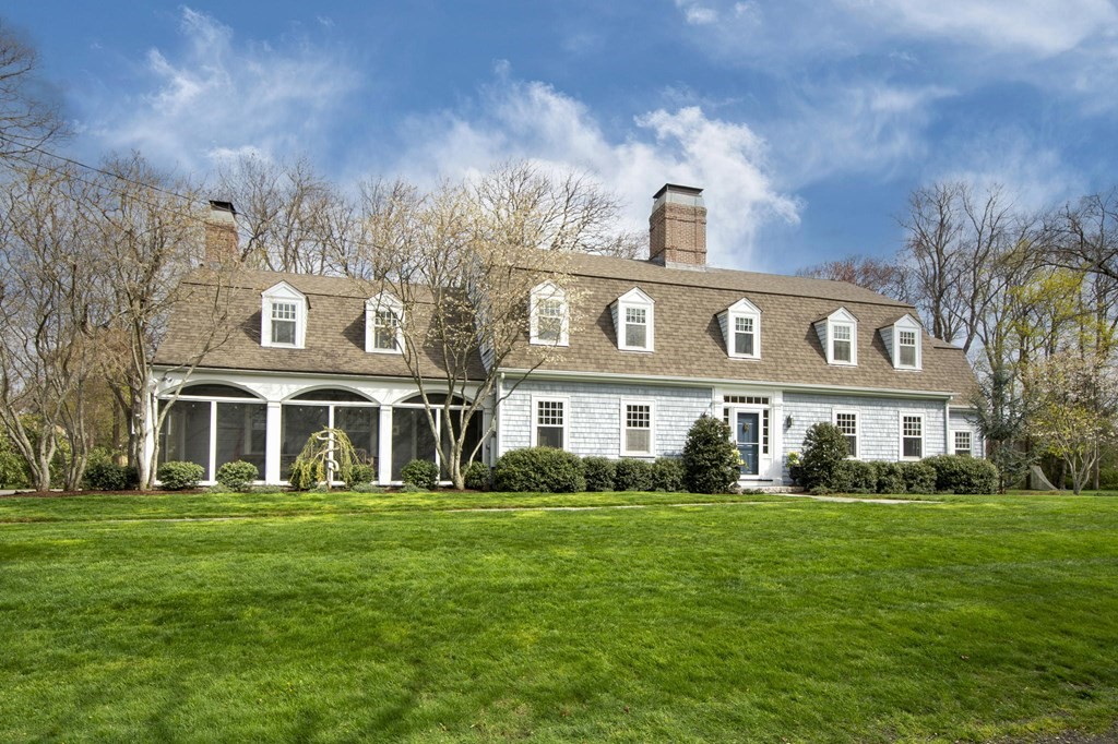 a front view of a house with a garden