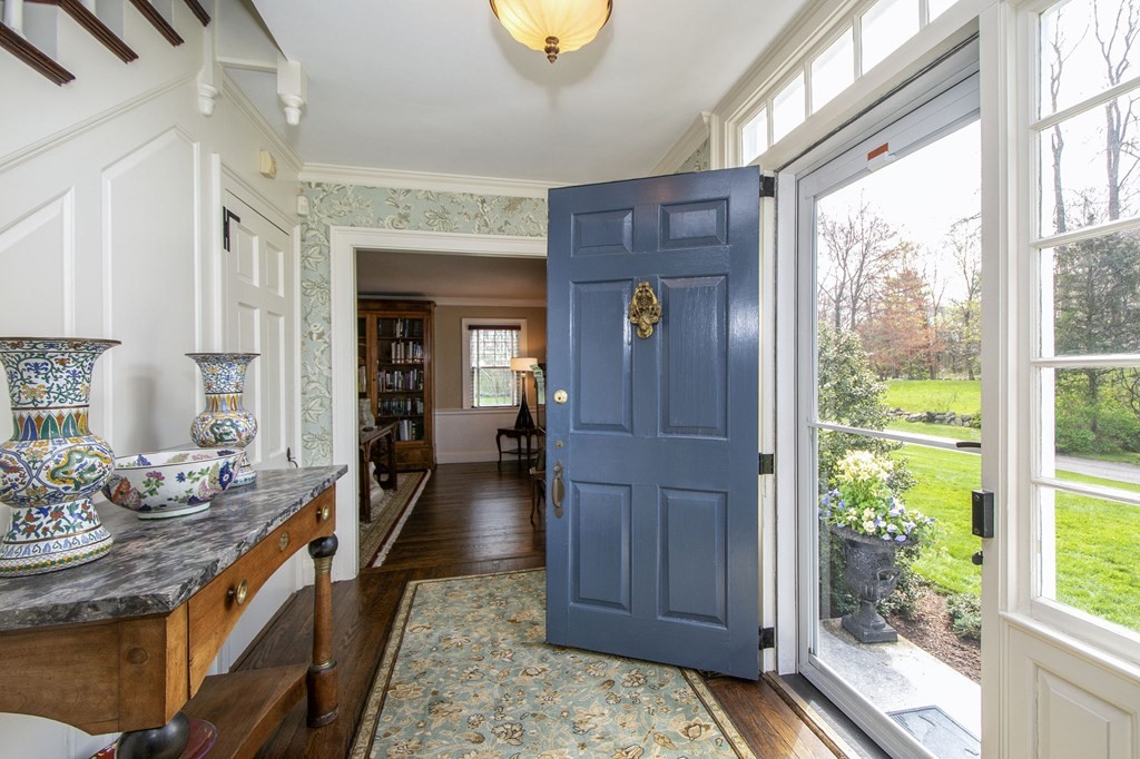 10 River Road Cohasset, MA 02025 - Photo 12 of 42 a hallway with a table and chairs in a room