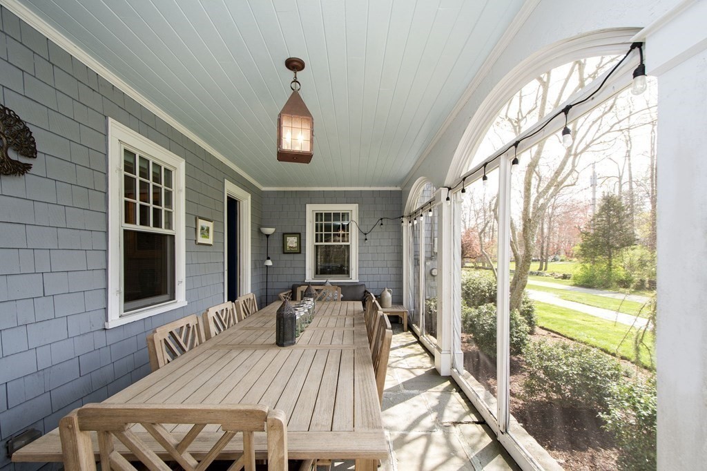 10 River Road Cohasset, MA 02025 - Photo 18 of 42 a view of a patio with table and chairs and wooden floor