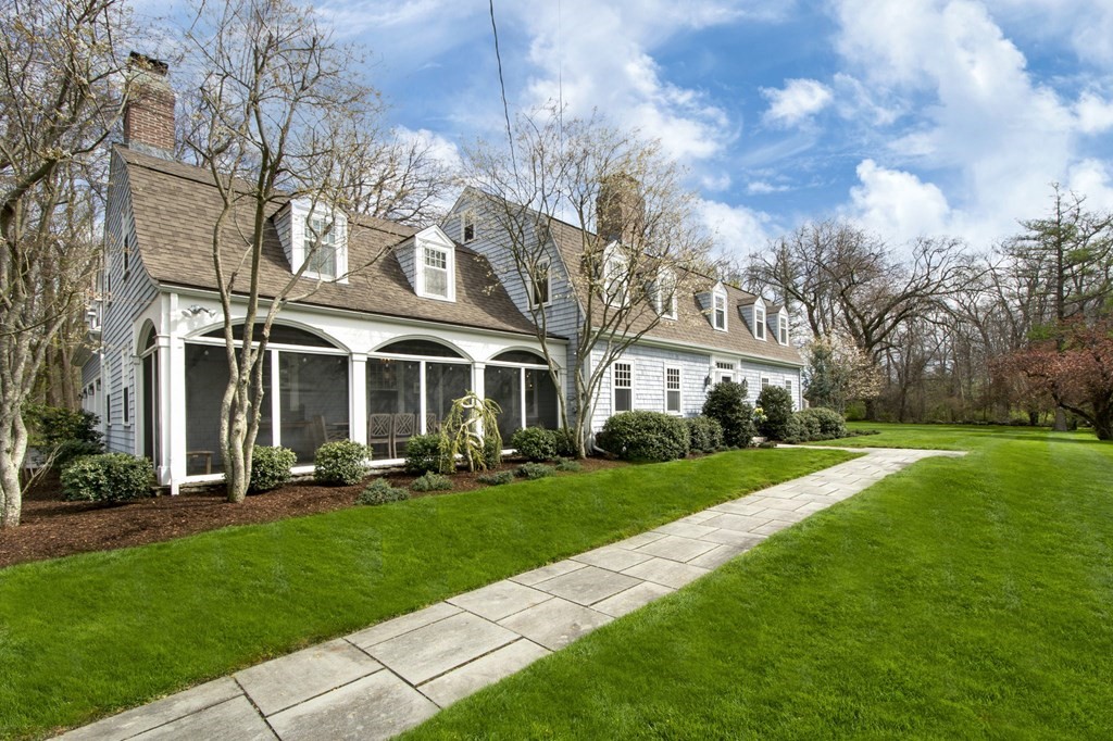 10 River Road Cohasset, MA 02025 - Photo 2 of 42 a front view of a building with garden