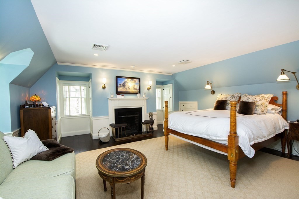 10 River Road Cohasset, MA 02025 - Photo 28 of 42 a bed room with a bed and a fireplace