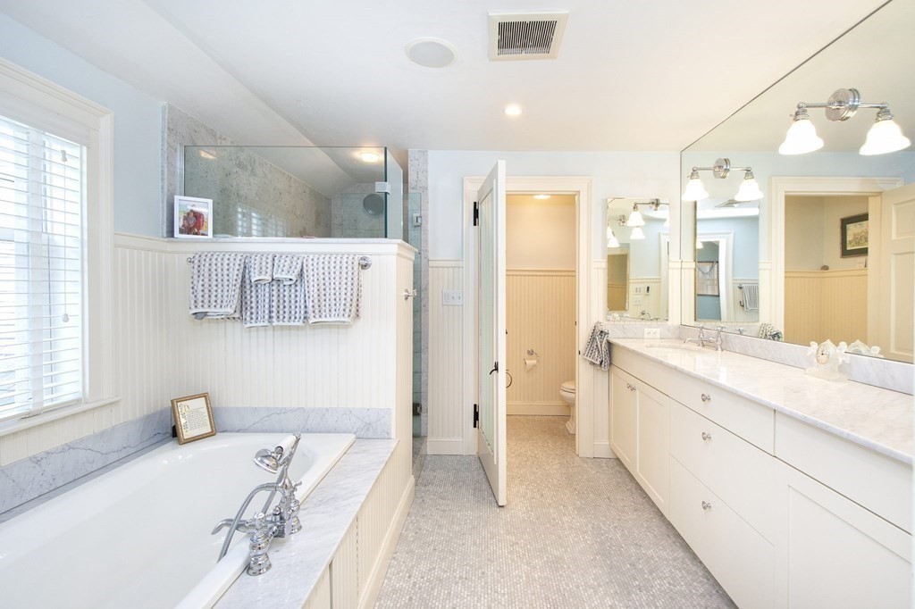 10 River Road Cohasset, MA 02025 - Photo 30 of 42 a spacious bathroom with a double vanity sink a mirror and a shower