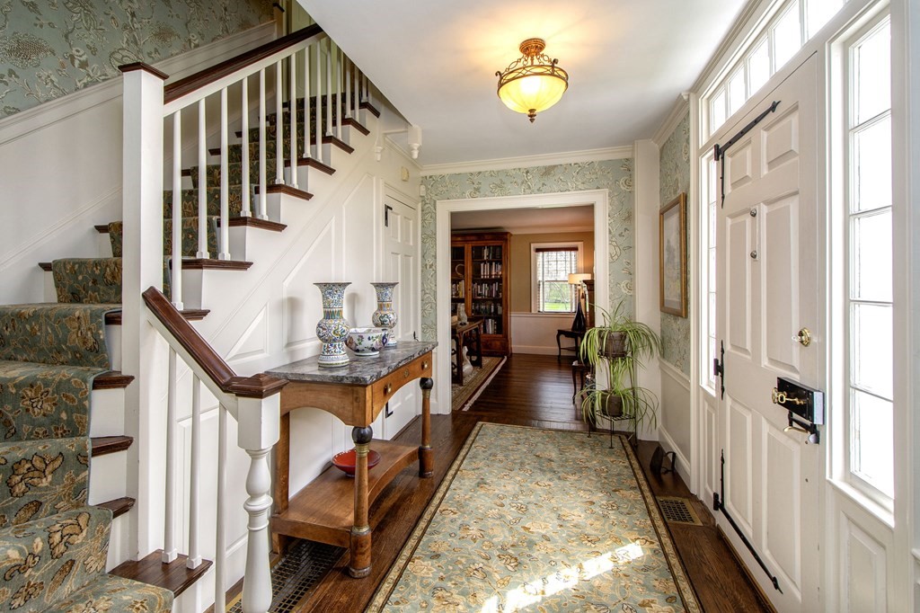 10 River Road Cohasset, MA 02025 - Photo 10 of 42 a view of a hallway to a livingroom with wooden floor and staircase