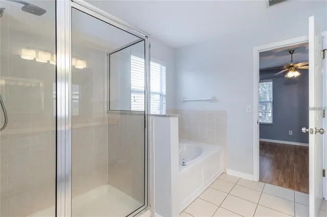 a bathroom with a bathtub and shower
