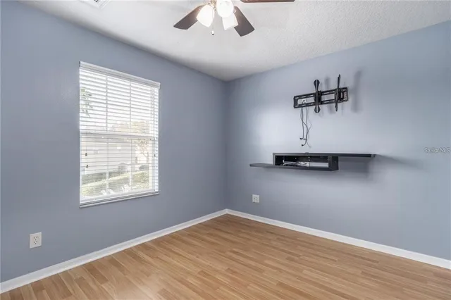 a view of a room with wooden floor and a window
