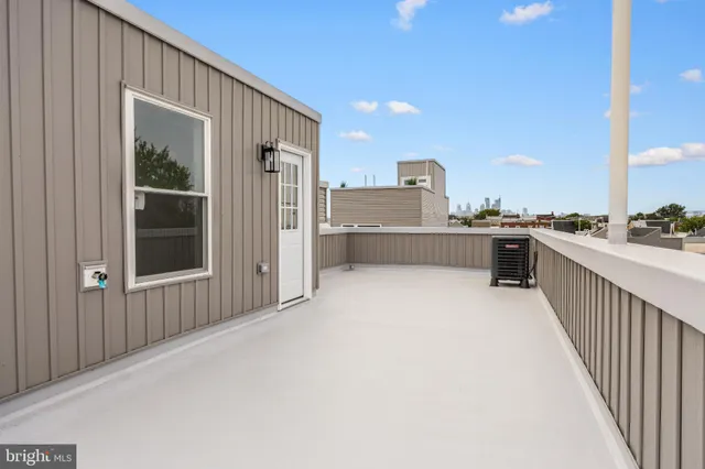 a view of roof deck with a barbeque and wooden fence