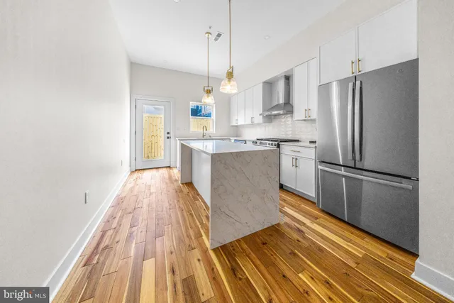 a kitchen with a stove a sink and a refrigerator
