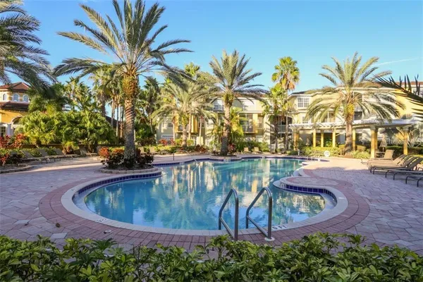 a view of swimming pool with outdoor seating and plants