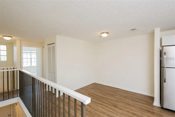 a view of hallway with wooden floor