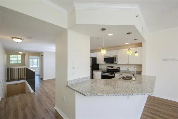 a kitchen with a sink a stove and cabinets