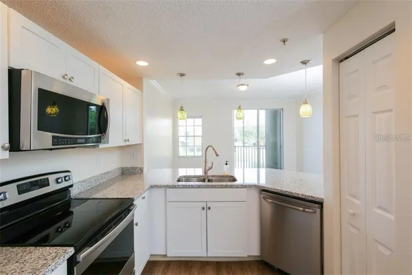 a kitchen with a sink and microwave