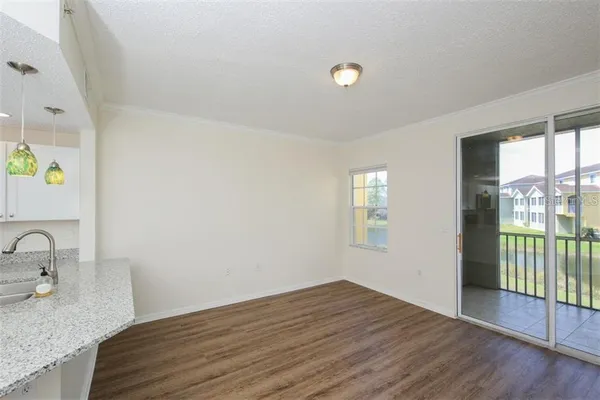 a view of a kitchen cabinets a sink and wooden floor
