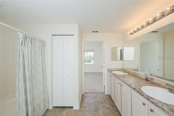 a bathroom with 2 sink and a mirror