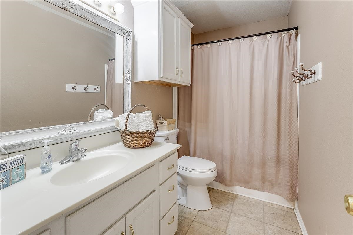 5307 69th Street Lubbock, TX 79424 - Photo 15 of 22 a bathroom with a sink toilet and shower