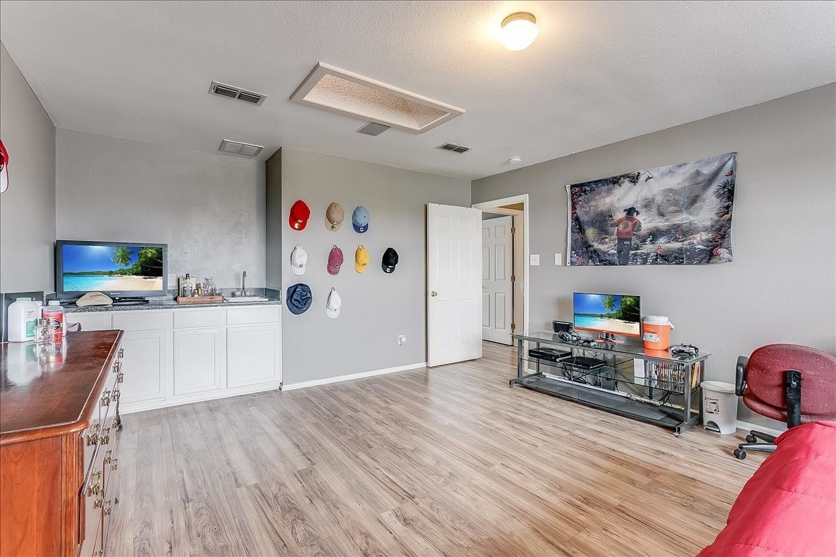 5307 69th Street Lubbock, TX 79424 - Photo 16 of 22 a view of a workspace with furniture and wooden floor