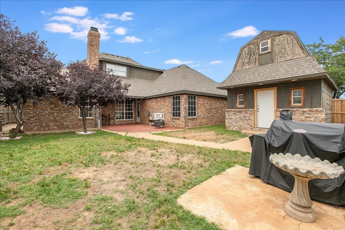 5307 69th Street Lubbock, TX 79424 - Photo 2 of 22 a front view of a house with garden
