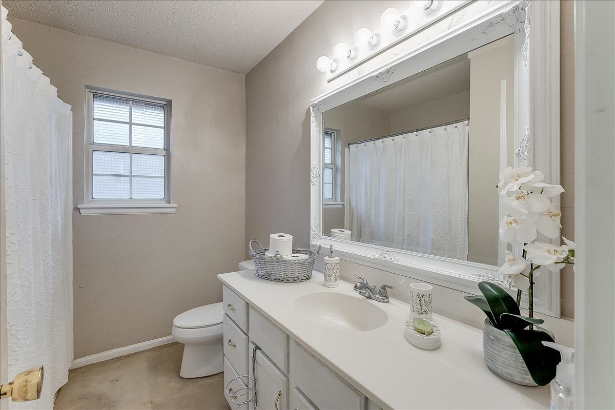 5307 69th Street Lubbock, TX 79424 - Photo 6 of 22 a bathroom with a sink and a mirror