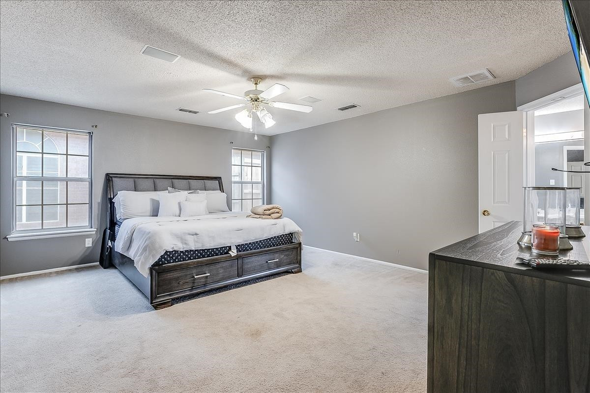 5307 69th Street Lubbock, TX 79424 - Photo 7 of 22 a spacious bedroom with a bed and window