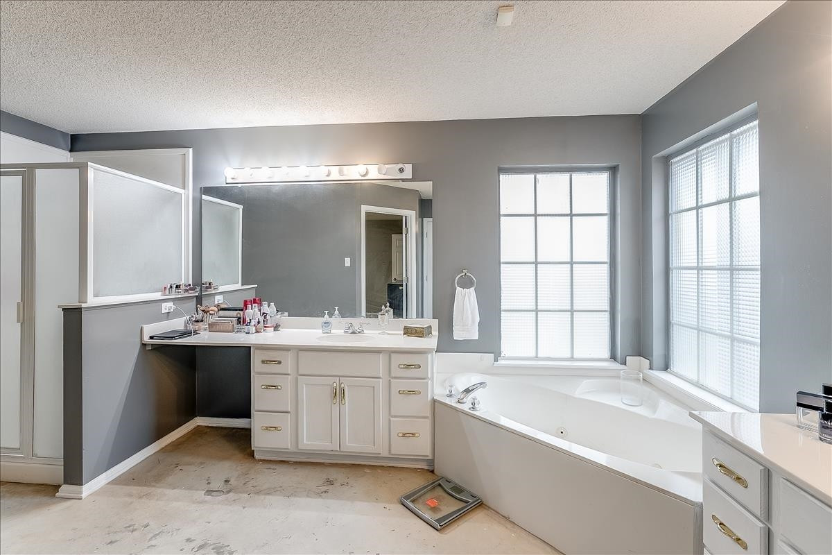 5307 69th Street Lubbock, TX 79424 - Photo 10 of 22 a large bathroom with a large tub sink and double vanity