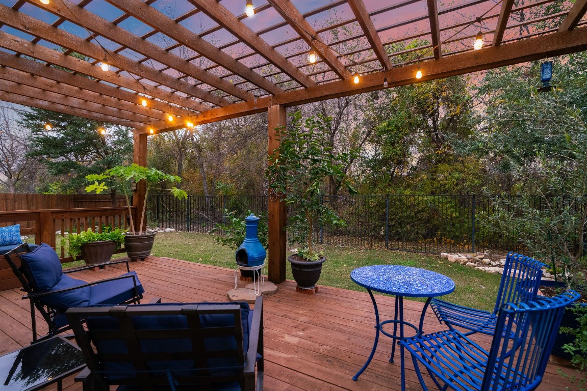 a backyard of a house with barbeque oven table and chairs