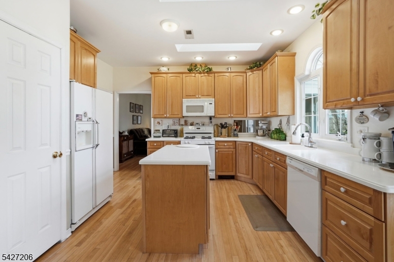 140 Bunker Hill Road Princeton, NJ 08540 - Photo 12 of 44 a kitchen with stainless steel appliances a sink a counter top space a large window and cabinets