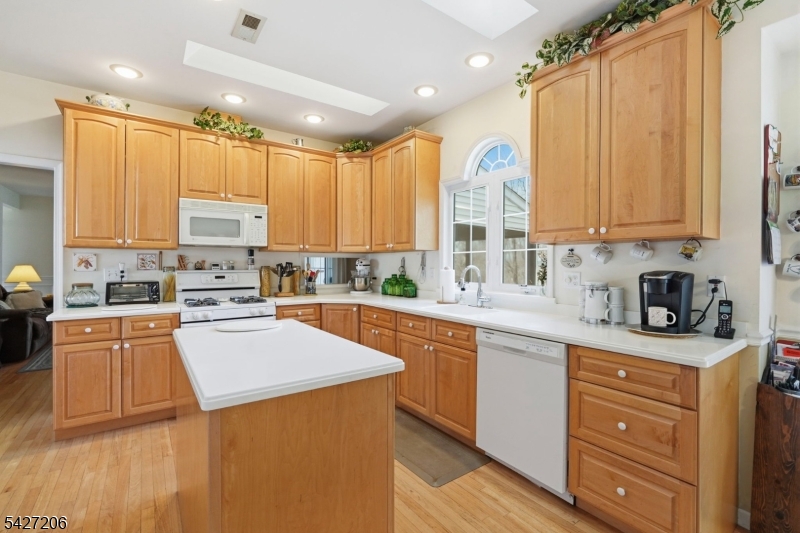 140 Bunker Hill Road Princeton, NJ 08540 - Photo 13 of 44 a kitchen with stainless steel appliances granite countertop a stove a sink dishwasher and a refrigerator with wooden floor