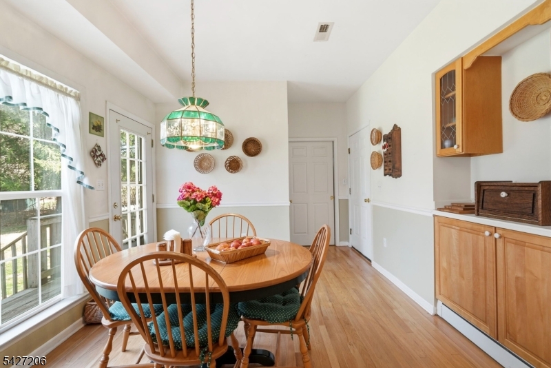 140 Bunker Hill Road Princeton, NJ 08540 - Photo 14 of 44 a view of a dining room with furniture wooden floor and a chandelier