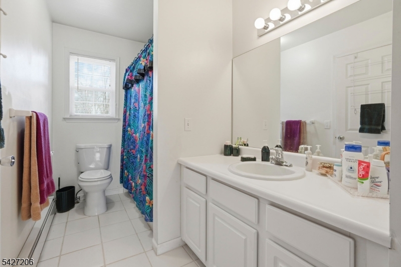 140 Bunker Hill Road Princeton, NJ 08540 - Photo 31 of 44 a bathroom with a sink vanity mirror and toilet