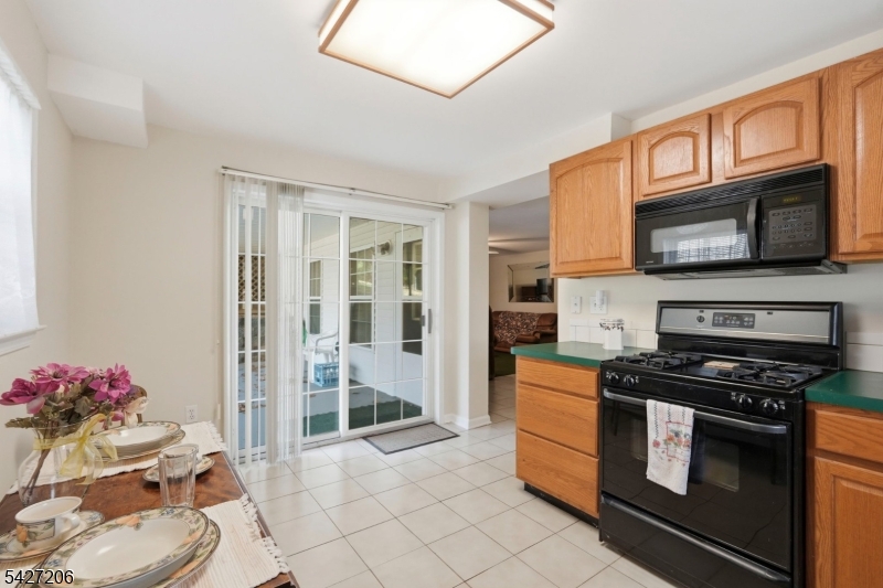 140 Bunker Hill Road Princeton, NJ 08540 - Photo 41 of 44 a kitchen with stainless steel appliances kitchen island granite countertop a stove a sink and a microwave