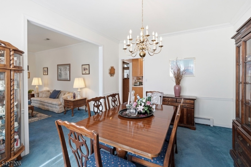 140 Bunker Hill Road Princeton, NJ 08540 - Photo 9 of 44 a view of a dining room with furniture a chandelier and wooden floor