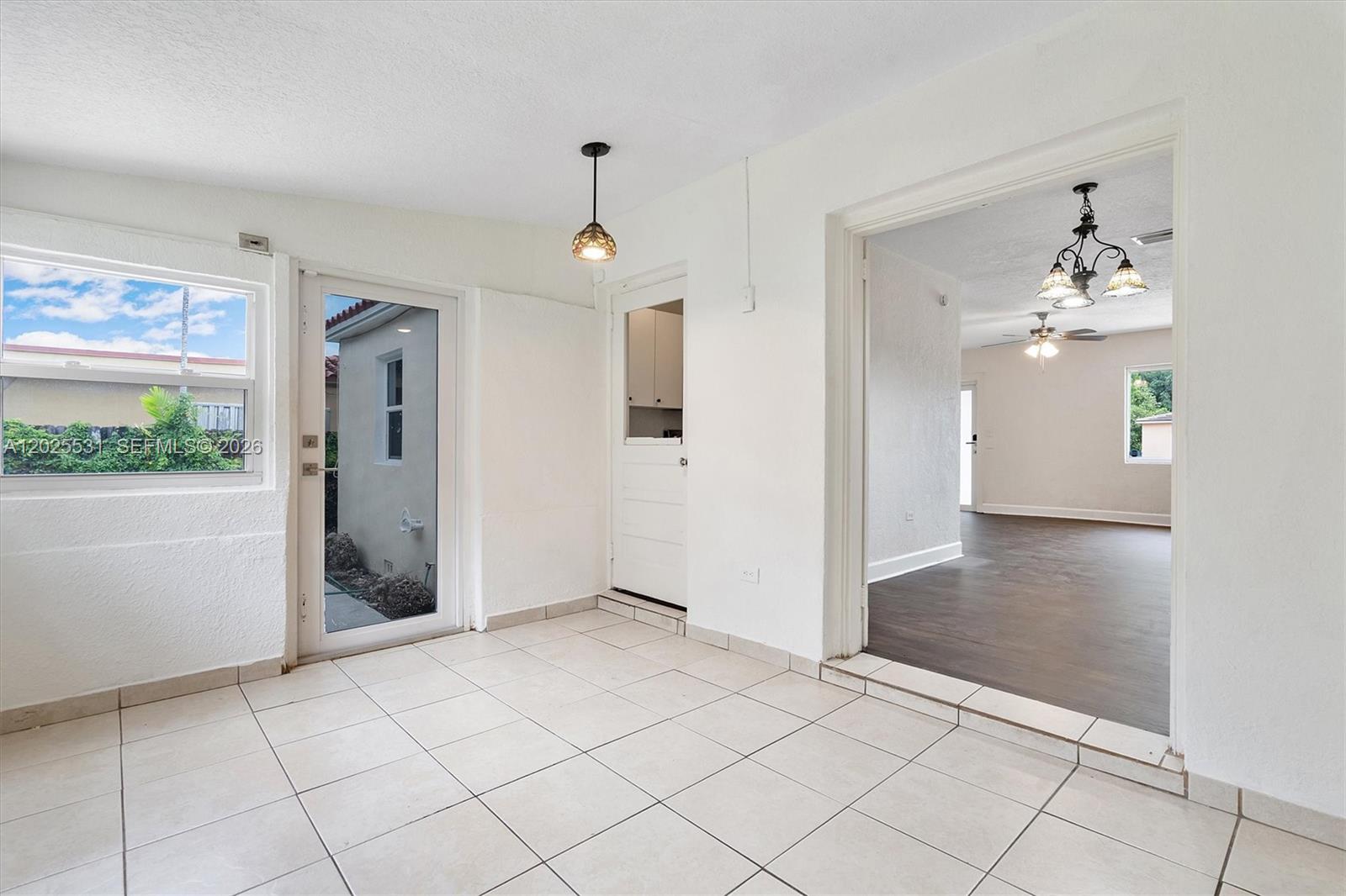 3951 Southwest 2nd Terrace, Unit 3951 Miami, FL 33134 - Photo 6 of 21 an empty room with kitchen and windows