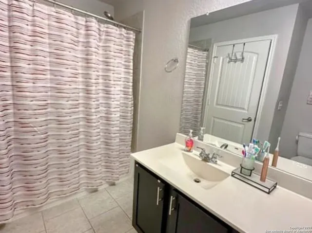 a bathroom with a sink a vanity and a mirror