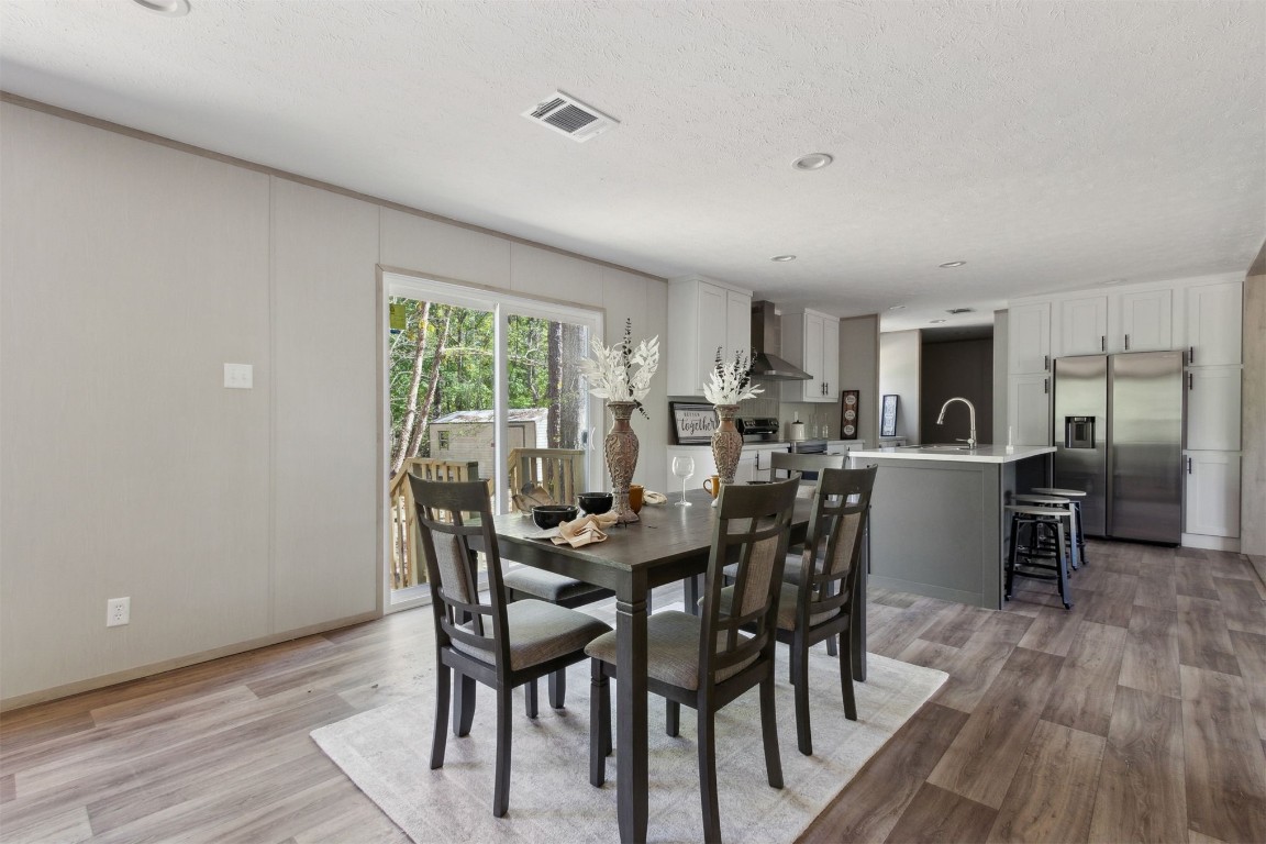 54178 Bea Road Callahan, FL 32011 - Photo 15 of 36 a view of a dining room with furniture and wooden floor