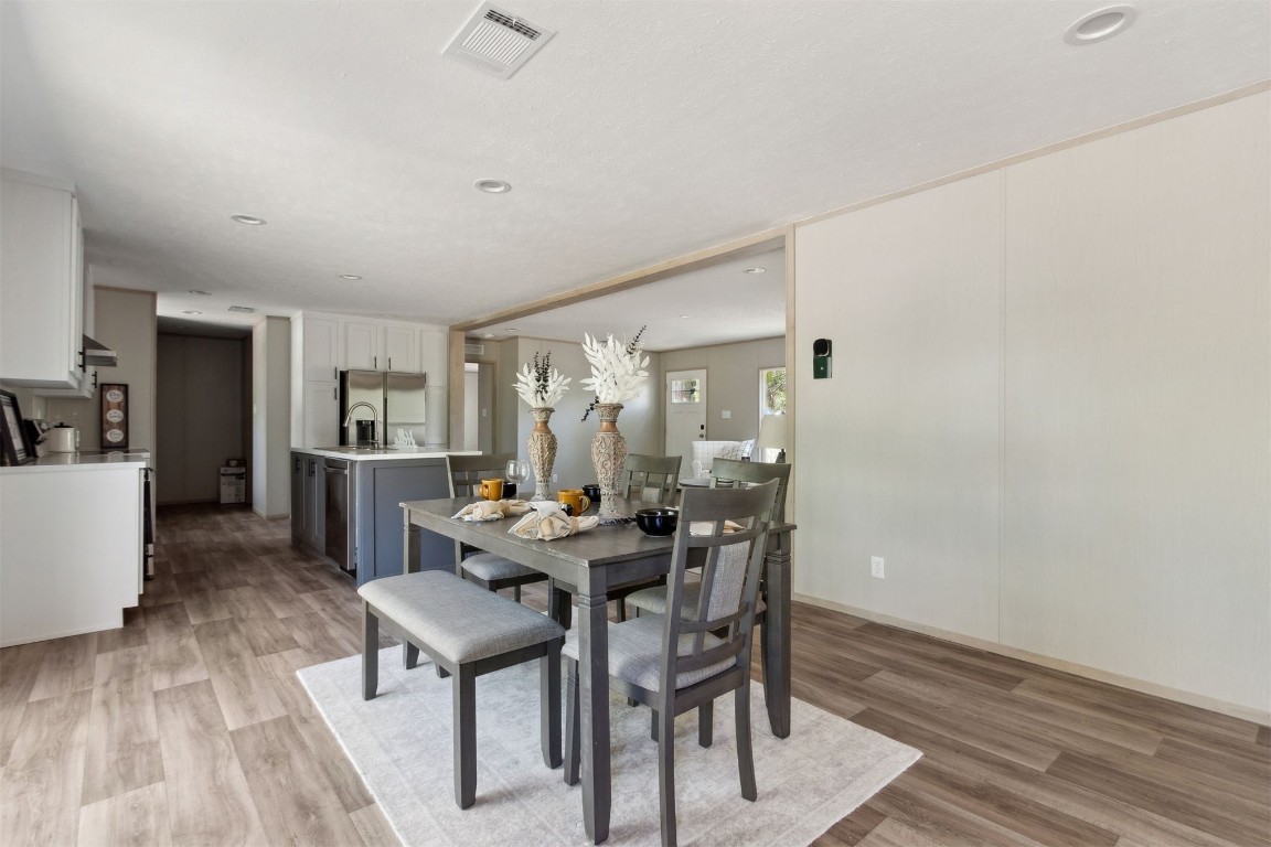 54178 Bea Road Callahan, FL 32011 - Photo 16 of 36 a view of a dining room with furniture and wooden floor