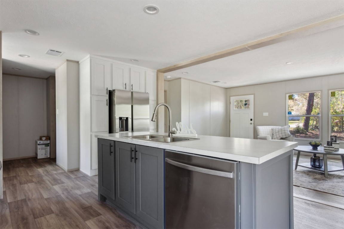 54178 Bea Road Callahan, FL 32011 - Photo 18 of 36 a kitchen with a sink cabinets and wooden floor