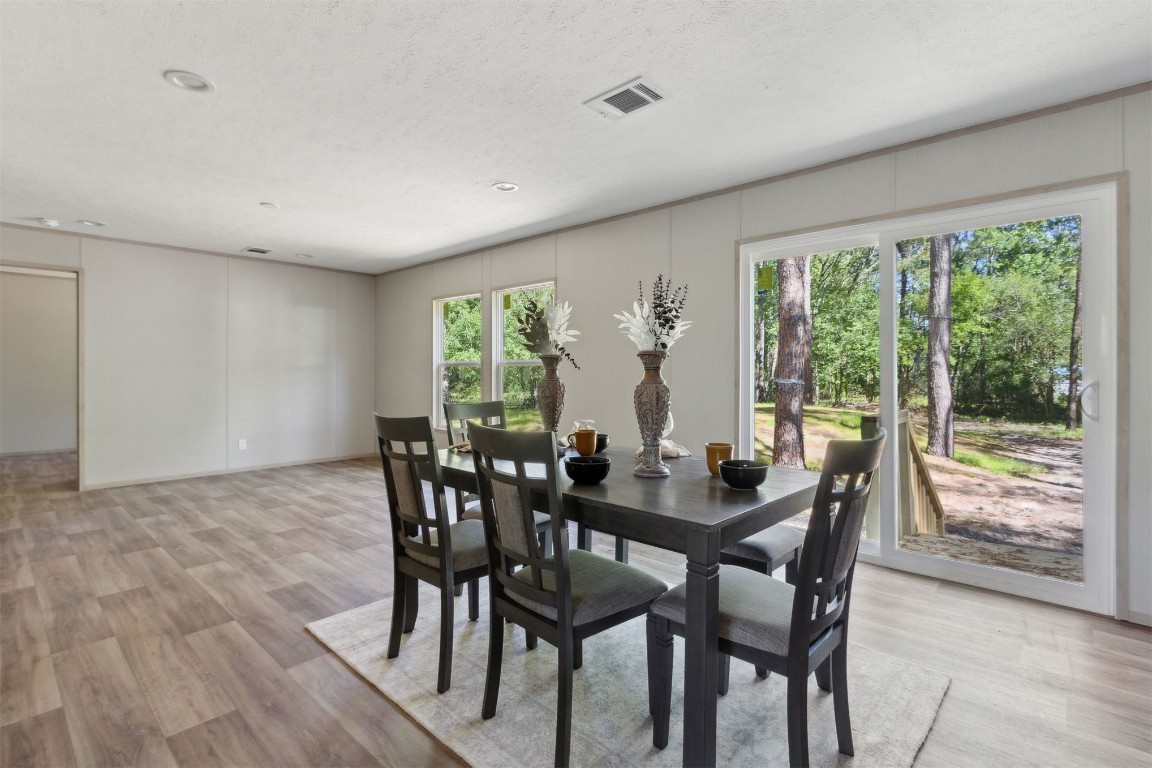 54178 Bea Road Callahan, FL 32011 - Photo 3 of 36 a view of a dining room with furniture and wooden floor