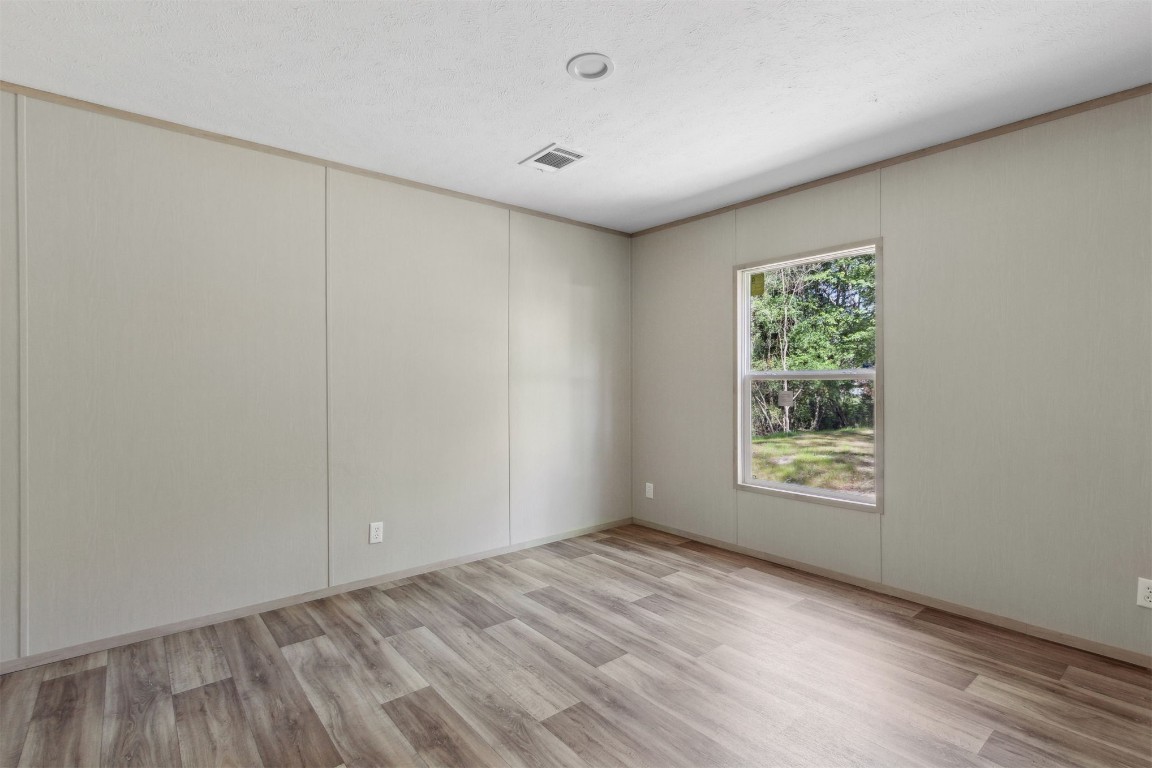 54178 Bea Road Callahan, FL 32011 - Photo 32 of 36 an empty room with wooden floor and windows