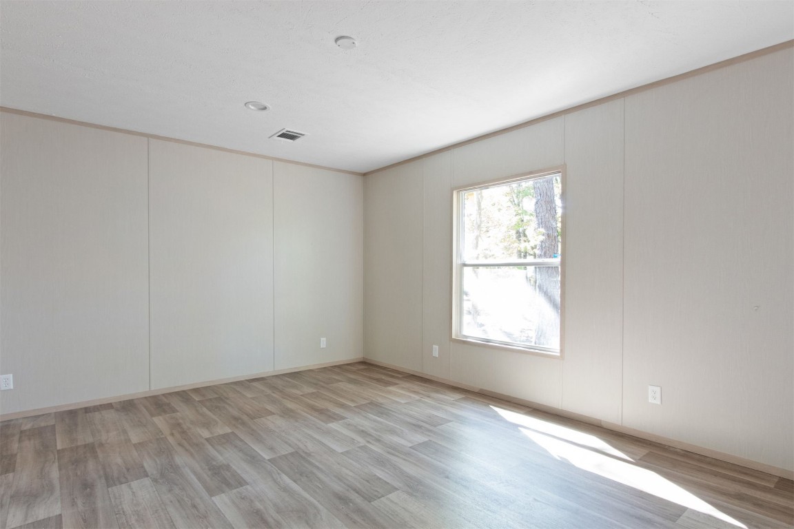 54178 Bea Road Callahan, FL 32011 - Photo 5 of 36 an empty room with wooden floor and windows