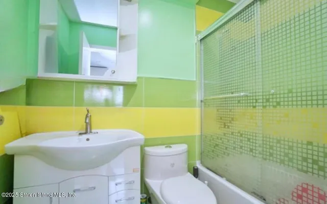 a bathroom with a sink a toilet and mirror