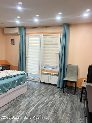 a view of a room with furniture and wooden floor