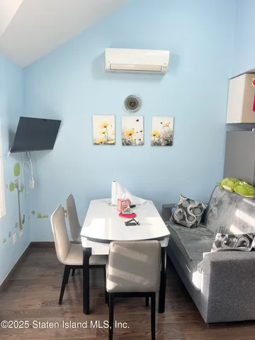 a reading room with furniture and a wooden floor