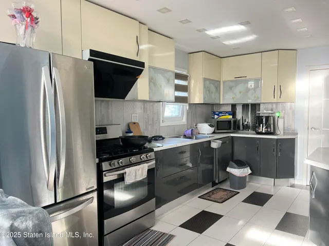 a kitchen with a sink stainless steel appliances and cabinets