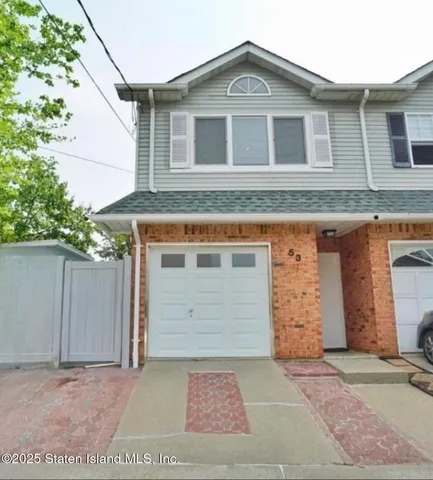 a front view of a house with a garage